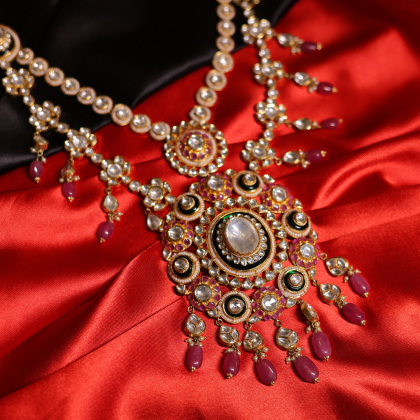 A handcrafted bridal necklace featuring Polki, Kundan, and ruby accents in royal Indian design.