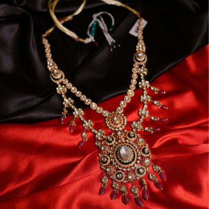 A handcrafted bridal necklace featuring Polki, Kundan, and ruby accents in royal Indian design.